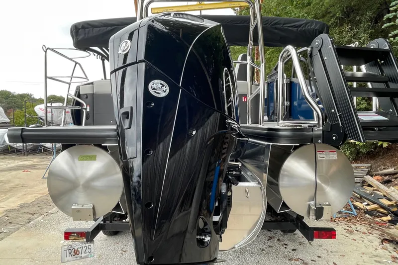 Slide: The Image of 2026 Harris Sunliner 210 boat with powerful outboard motor and sleek design. - 22