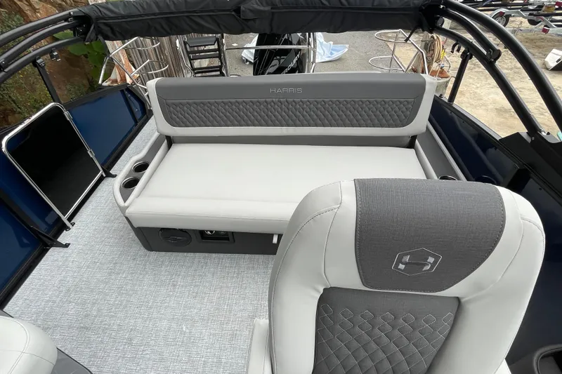 Slide: The Image of 2026 Harris Sunliner 210 boat interior with gray seating and cup holders. - 9