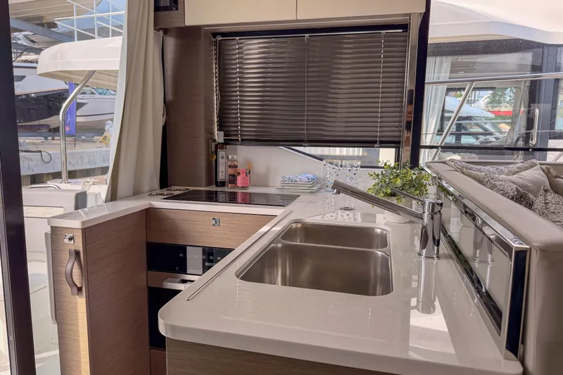 Slide: The Image of 2025 Jeanneau NC 1295 Fly yacht deck with scenic waterfront view. - 10