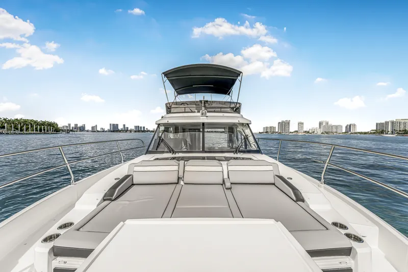 Slide: The Image of 2025 Jeanneau NC 1295 Fly yacht on water, featuring spacious deck and modern design. - 20