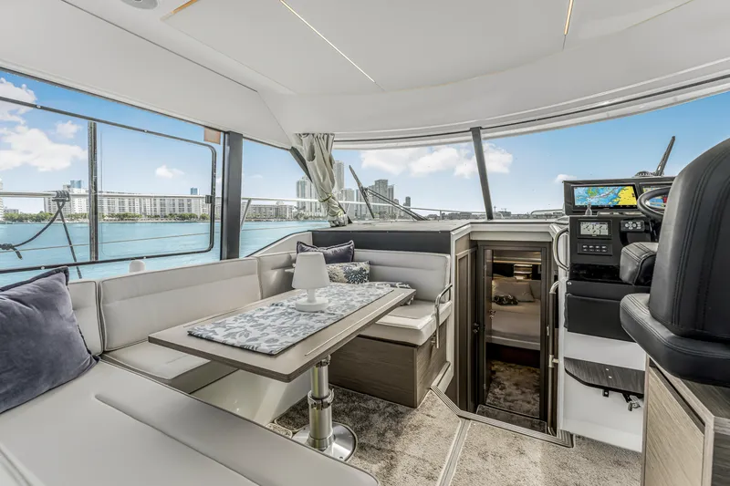 Slide: The Image of Luxurious interior of 2025 Jeanneau NC 1295 Fly yacht with city skyline view. - 24
