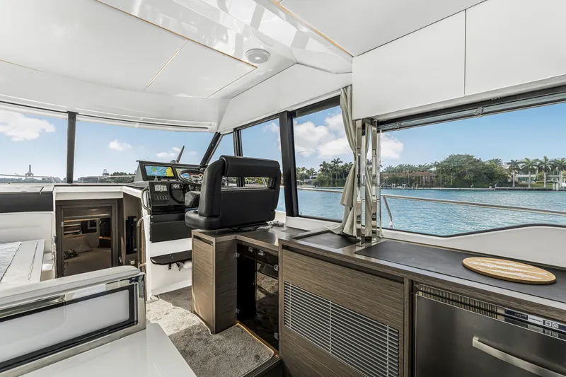 Slide: The Image of Interior of 2025 Jeanneau NC 1295 Fly yacht with modern helm and waterfront view. - 26