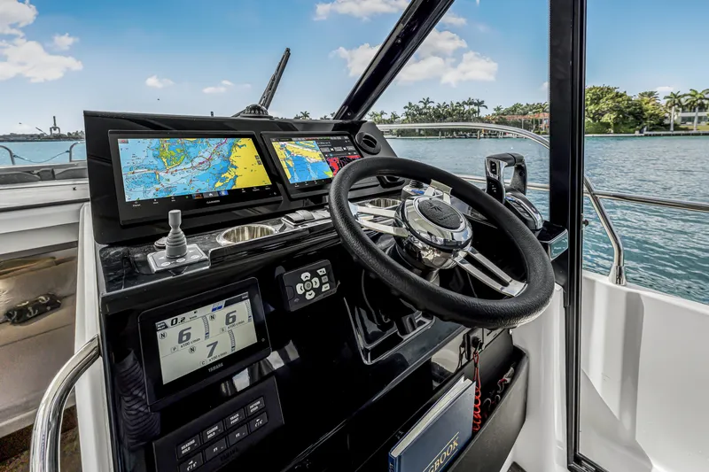 Slide: The Image of Cockpit of 2025 Jeanneau NC 1295 Fly with navigation screens and steering wheel. - 27