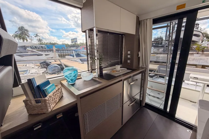 Slide: The Image of 2025 Jeanneau NC 1295 Fly yacht illuminated at sunset on calm waters. - 6