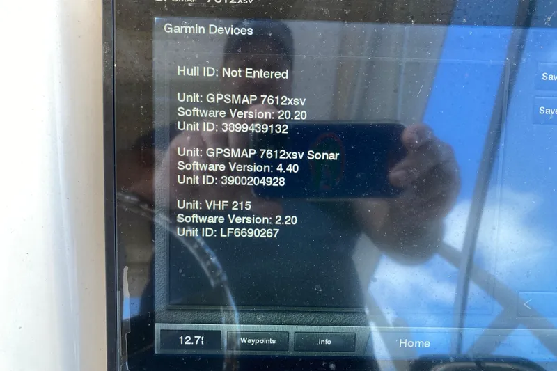 Slide: The Image of 2015 Grady-White Freedom 285 boat dashboard with steering wheel, Garmin display, and Yamaha controls. - 13