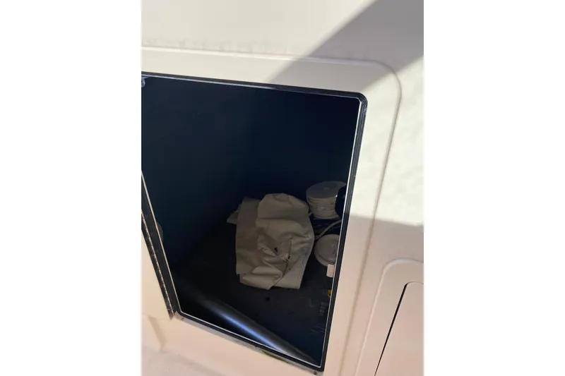 Slide: The Image of 2015 Grady-White Freedom 285 boat cabin with life jackets and toilet. - 15