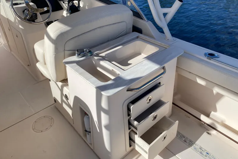 Slide: The Image of Storage compartment on 2015 Grady-White Freedom 285 boat with items inside. - 16