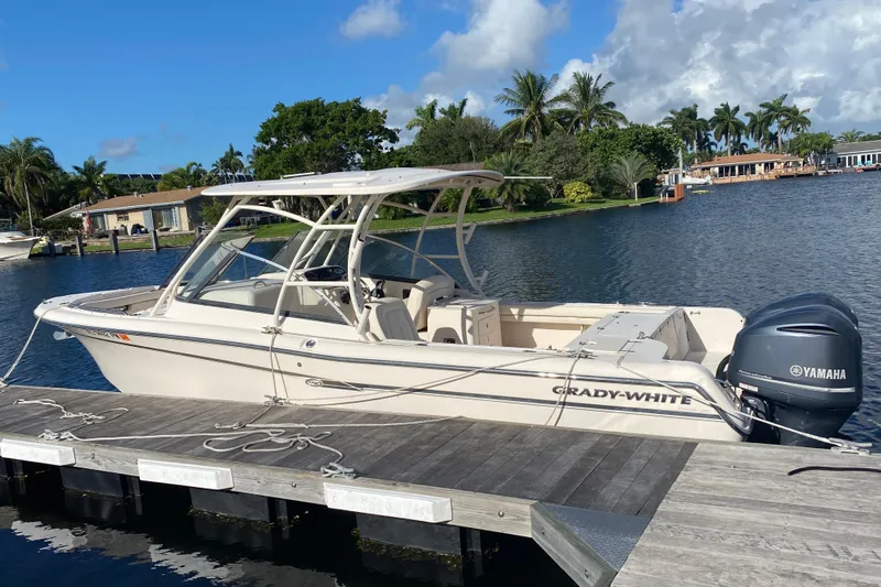 Slide: The Image of 2015 Grady-White Freedom 285 boat interior with cushioned seating and storage compartments. - 3