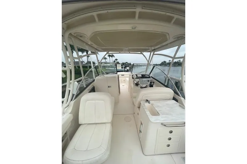 Slide: The Image of 2015 Grady-White Freedom 285 boat docked on a lift by the water. - 6