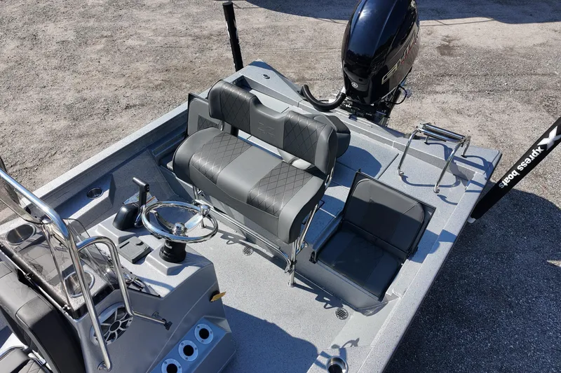 Slide: The Image of 2026 Xpress H24B Bay boat interior with seating and steering wheel, featuring modern design. - 14