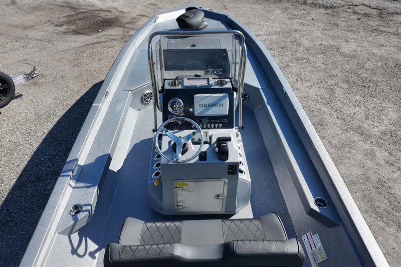 Slide: The Image of 2026 Xpress H24B Bay boat interior with Garmin navigation system and steering console. - 17