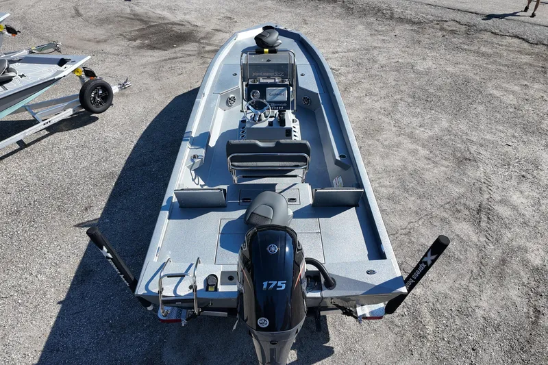 Slide: The Image of 2026 Xpress H24B Bay boat with Yamaha 175 engine on gravel surface. - 7