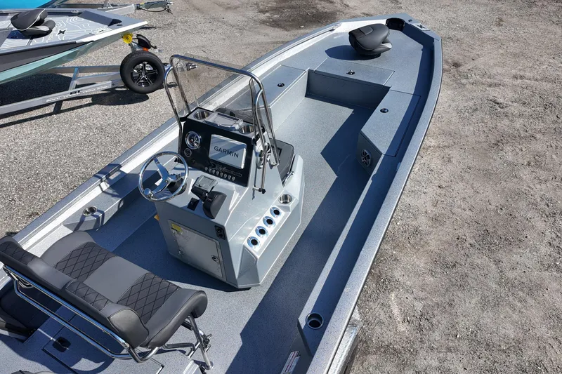 Slide: The Image of 2026 Xpress H24B Bay boat with Garmin navigation, sleek design, and spacious seating. - 9