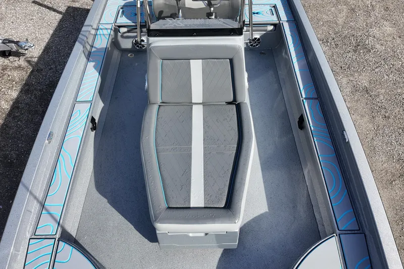 Slide: The Image of 2026 Xpress X23B Bay Lounge boat interior with gray seating and blue accents. - 15