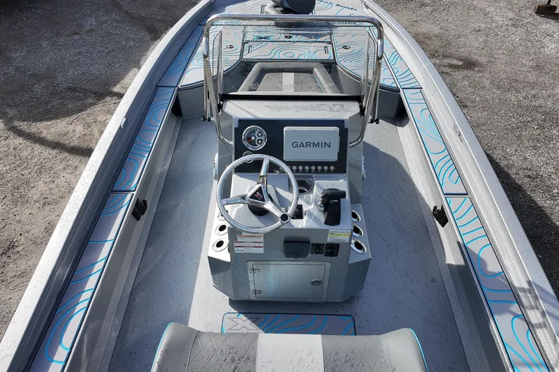 Slide: The Image of 2026 Xpress X23B Bay Lounge boat interior with Garmin navigation system. - 18
