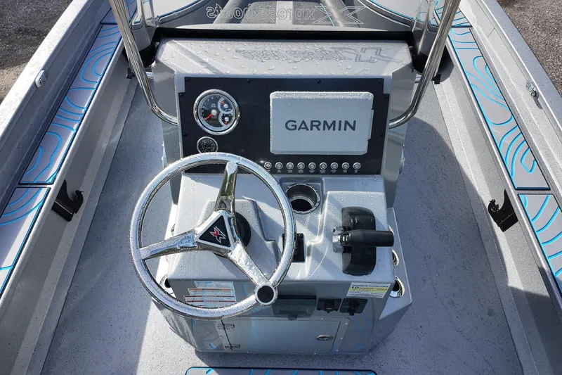 Slide: The Image of 2026 Xpress X23B Bay Lounge boat console with Garmin navigation system and steering wheel. - 19