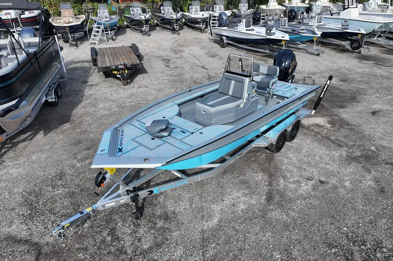Slide: The Image of 2026 Xpress X23B Bay Lounge boat on trailer, surrounded by other boats in a lot. - 5