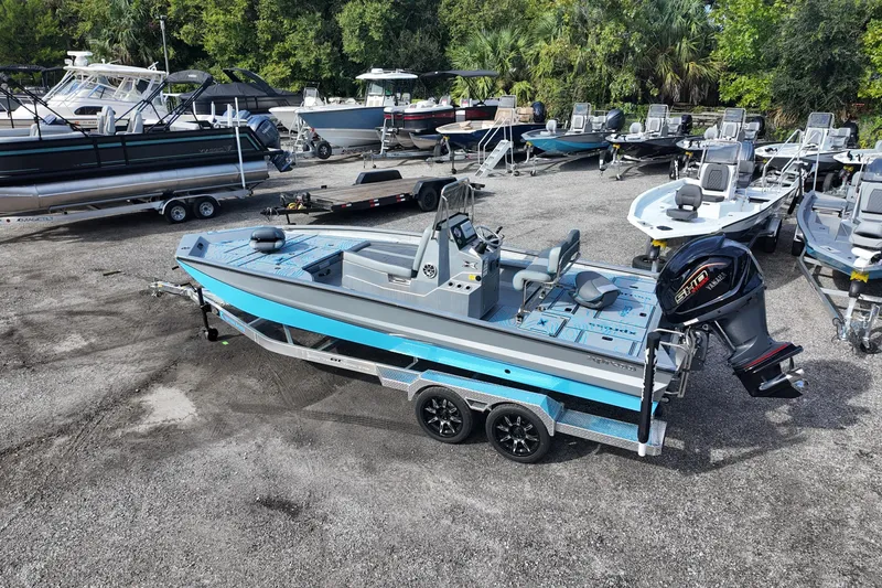 Slide: The Image of 2026 Xpress X23B Bay Lounge boat on trailer in marina lot. - 7