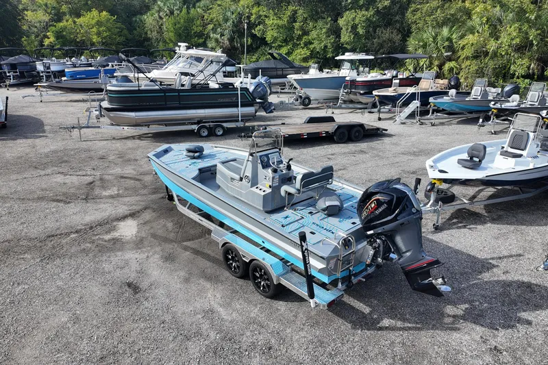 Slide: The Image of 2026 Xpress X23B Bay Lounge boat in a marina with various other boats. - 8