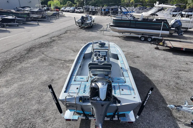 Slide: The Image of 2026 Xpress X23B Bay Lounge boat in a marina with other vessels. - 9