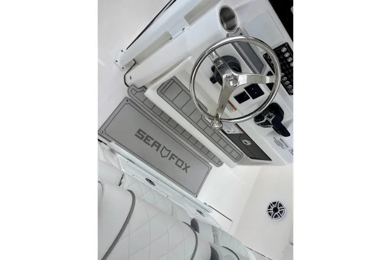 Slide: The Image of 2026 Sea Fox 288 Commander boat helm with steering wheel and controls. - 10