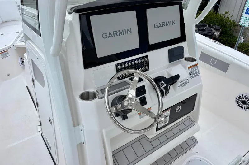 Slide: The Image of 2026 Sea Fox 288 Commander boat dashboard with dual Garmin displays and steering wheel. - 13