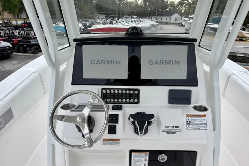 Slide: The Image of 2026 Sea Fox 288 Commander helm with dual Garmin displays and steering wheel. - 14