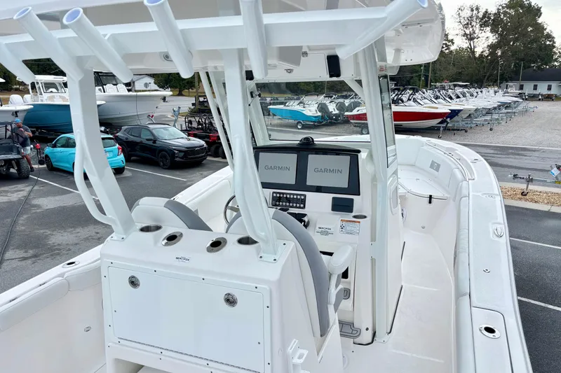 Slide: The Image of 2026 Sea Fox 288 Commander boat with Garmin navigation, parked in a marina lot. - 16