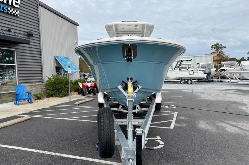 Slide: The Image of 2026 Sea Fox 288 Commander boat on trailer in parking lot, dealership background. - 21