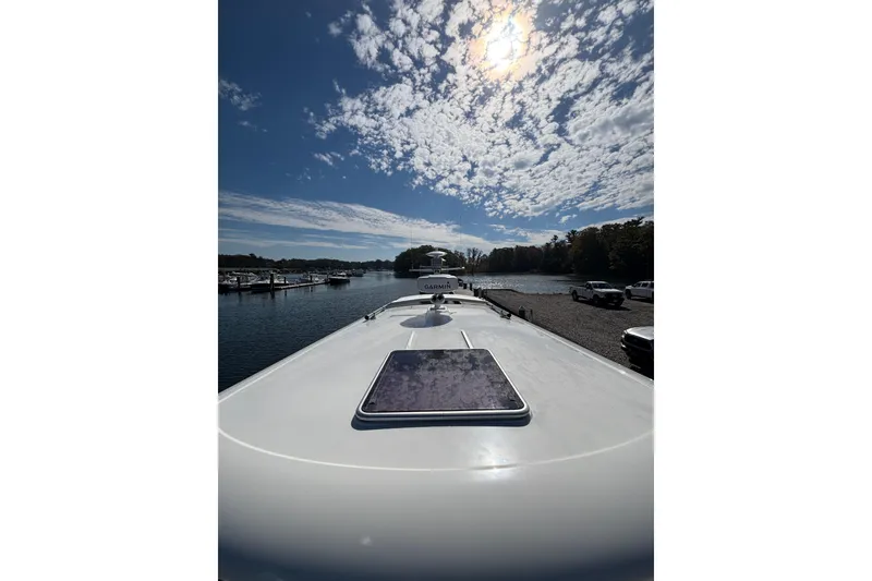 Slide: The Image of 2020 Back Cove 37 yacht on calm water under a partly cloudy sky. - 14