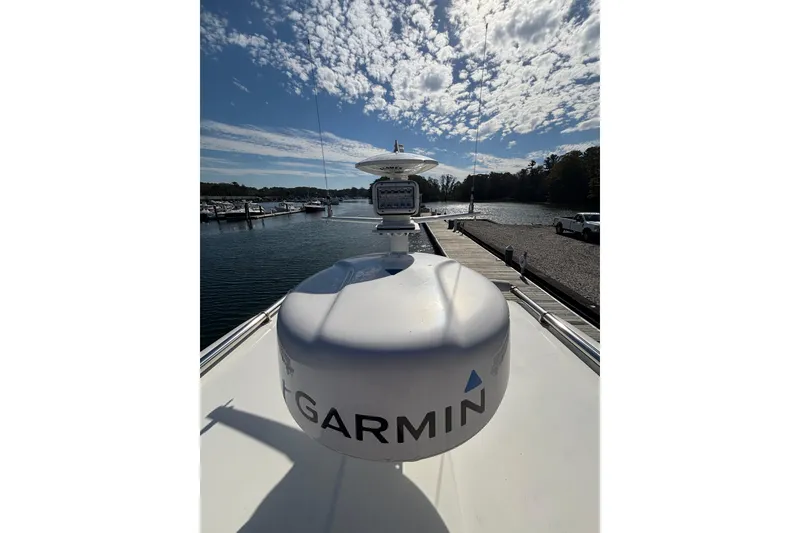 Slide: The Image of 2020 Back Cove 37 yacht with Garmin radar, docked under a partly cloudy sky. - 15