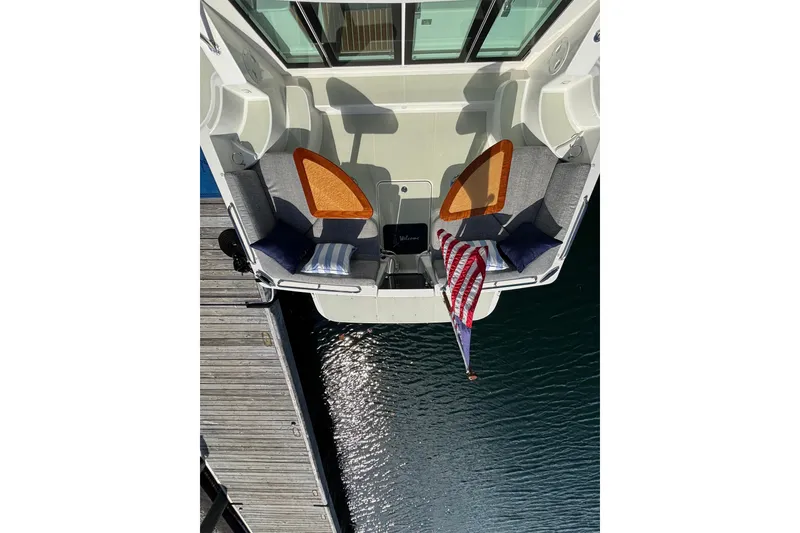 Slide: The Image of Aerial view of 2020 Back Cove 37 boat with seating and American flag. - 18