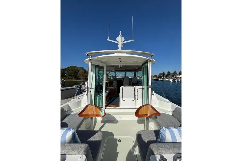 Slide: The Image of 2020 Back Cove 37 boat interior with seating, table, and open cabin view. - 20