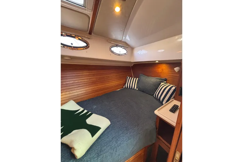 Slide: The Image of Cozy cabin interior of 2020 Back Cove 37 yacht with striped pillows and wooden paneling. - 34