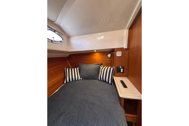Slide: The Image of Cozy cabin interior of 2020 Back Cove 37 with striped pillows and wooden accents. - 35