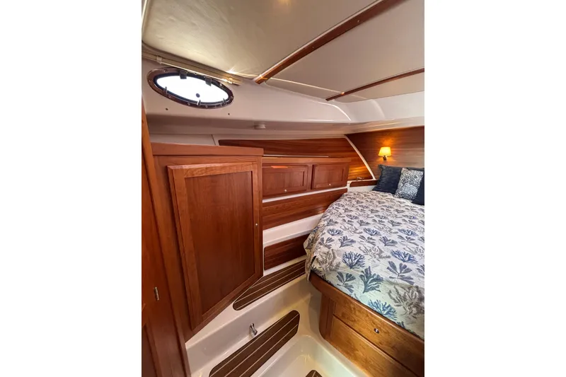 Slide: The Image of Luxurious cabin interior of 2020 Back Cove 37 yacht with wood finish and cozy bedding. - 38