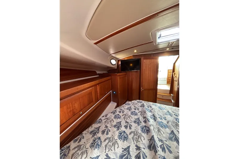 Slide: The Image of 2020 Back Cove 37 yacht interior with wood paneling and floral bedding. - 41