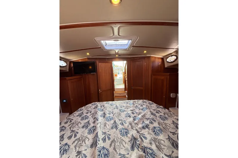 Slide: The Image of Cozy cabin interior of 2020 Back Cove 37 yacht with wood paneling and floral bedding. - 42
