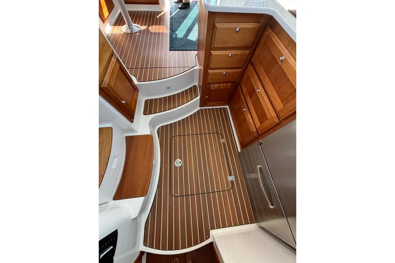 Slide: The Image of 2020 Back Cove 37 interior with wood cabinetry and striped flooring. - 48