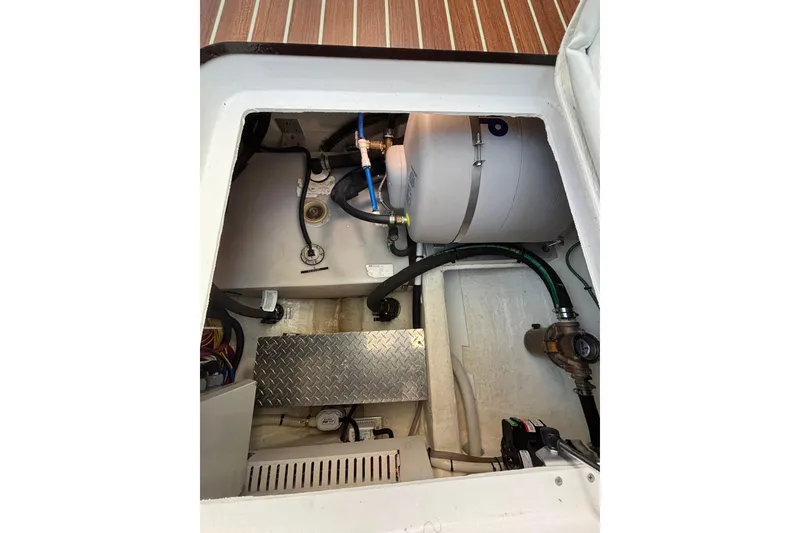 Slide: The Image of Engine compartment of a 2020 Back Cove 37 boat, showing mechanical components. - 49