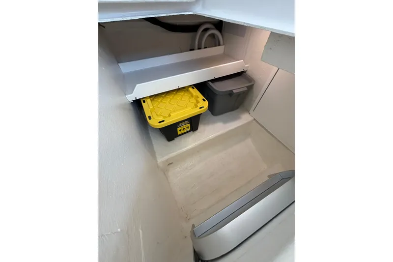 Slide: The Image of Storage compartment in a 2020 Back Cove 37 boat, featuring organized bins and clean interior. - 51
