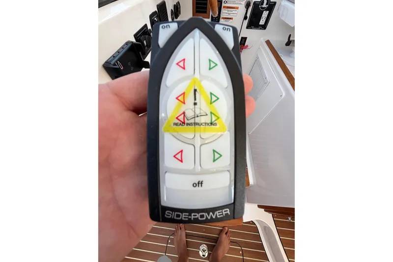 Slide: The Image of Hand holding Side-Power remote control on 2020 Back Cove 37 boat. - 61