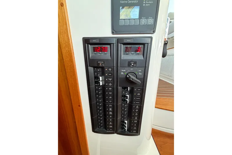 Slide: The Image of Control panel of a 2020 Back Cove 37 boat, featuring digital displays and switches. - 63