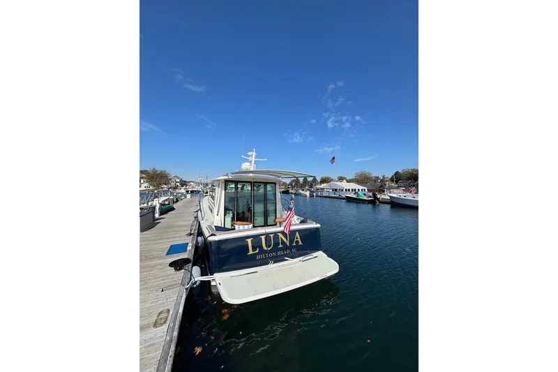 Slide: The Image of Back Cove 37 yacht, 2020 model, docked at marina under clear blue sky. - 7