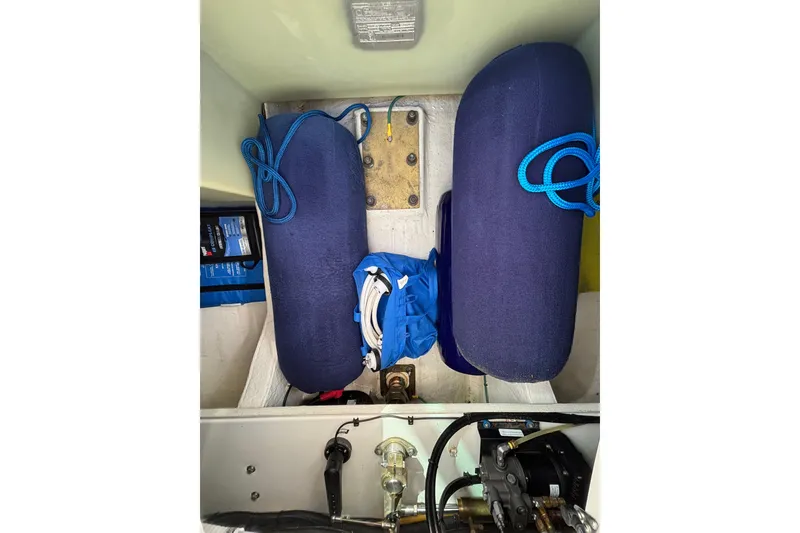 Slide: The Image of Storage compartment of a 2020 Back Cove 37 boat with blue fenders and ropes. - 74