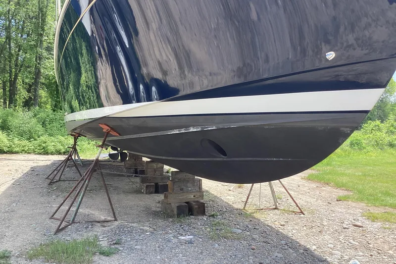 Slide: The Image of 2020 Back Cove 37 boat on stands, hull view in outdoor setting. - 80