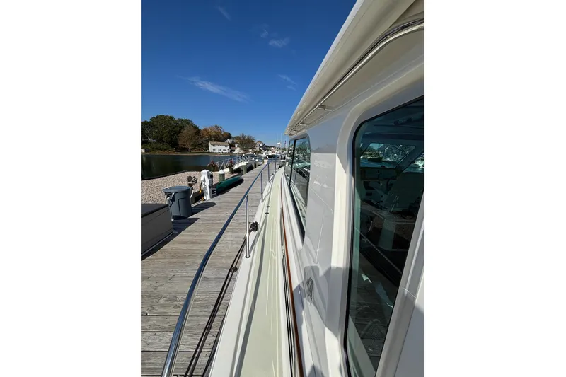 Slide: The Image of 2020 Back Cove 37 yacht docked, showcasing sleek design and waterfront view. - 9