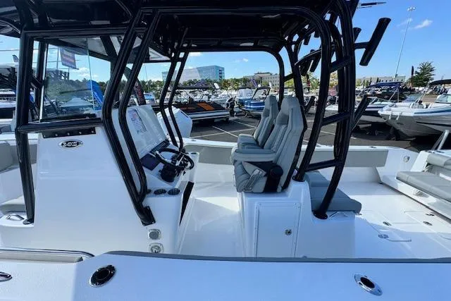 Slide: The Image of 2026 Cape Horn 34 XS boat interior with modern helm and seating at a marina. - 2