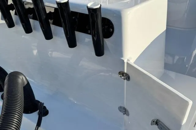 Slide: The Image of 2026 Cape Horn 34 XS boat detail with rod holders and storage compartment. - 24