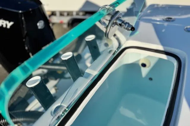 Slide: The Image of 2026 Cape Horn 34 XS boat detail with rod holders and windshield. - 20